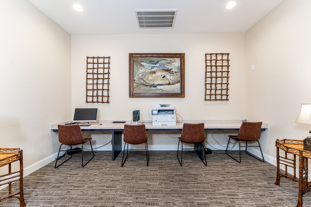 Business center with computer, printer, long desk and four chairs at Riverstone apartments for rent in Macon, GA