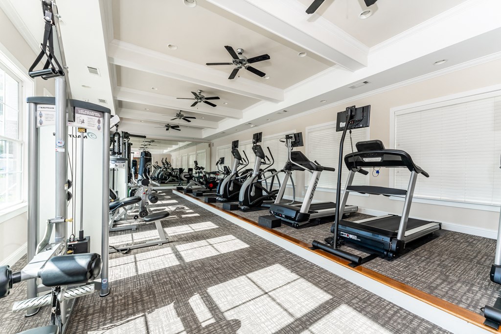 Premium fitness center with cardio equipment and weight machines at Riverstone apartments for rent in Macon, GA