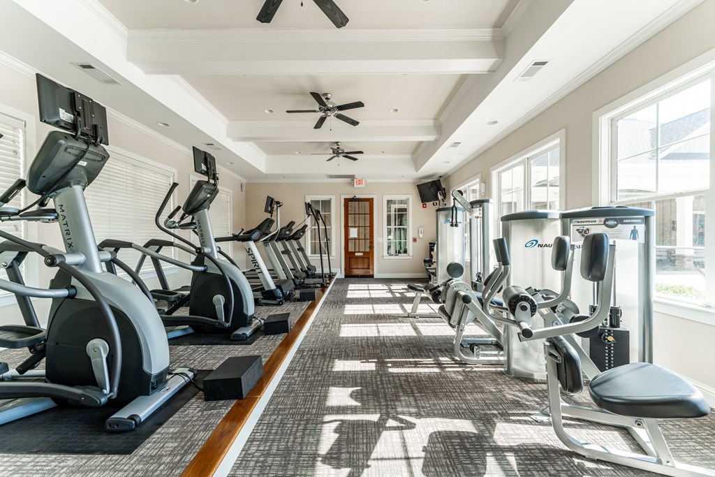 Premium fitness center with cardio equipment and weight machines at Riverstone apartments for rent in Macon, GA