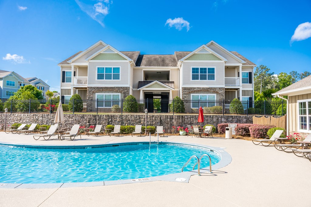 View of the outdoor sparkling swimming pool at Riverstone apartments for rent in Macon, GA