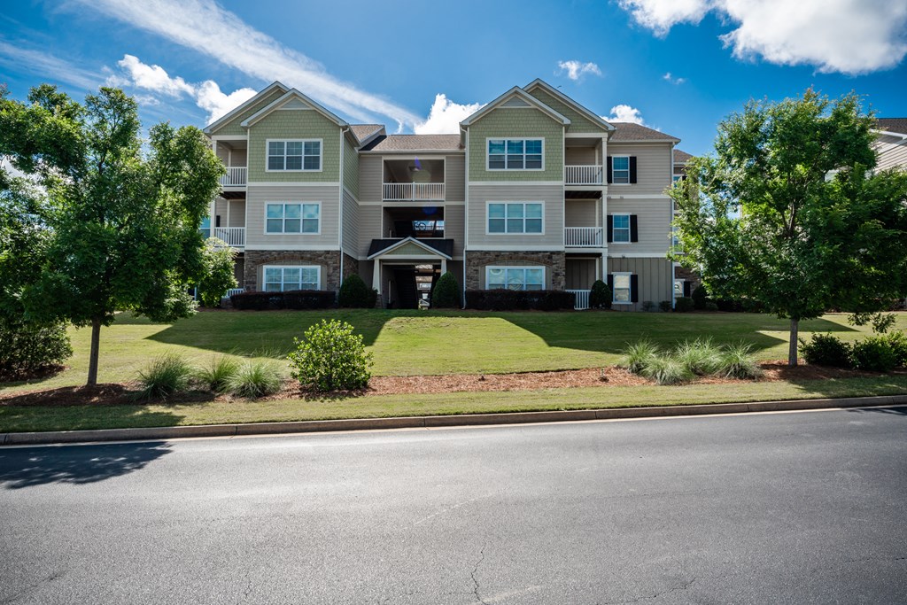 Residential building with beautiful landscaping at Riverstone apartments for rent in Macon, GA