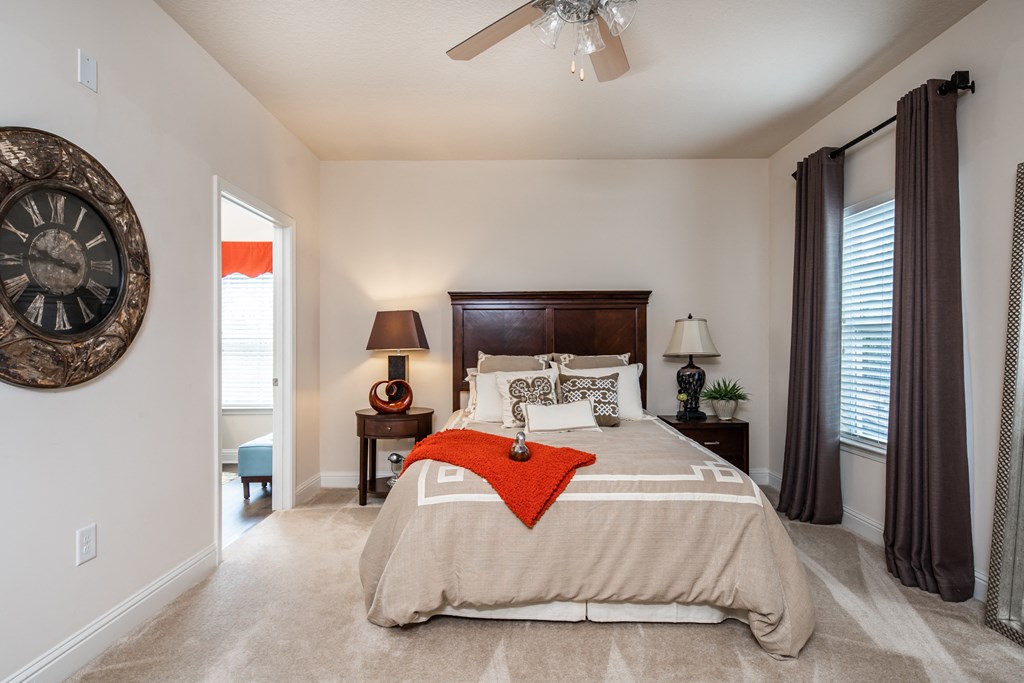 Furnished master bedroom with access to private bathroom at Riverstone apartments for rent in Macon, GA