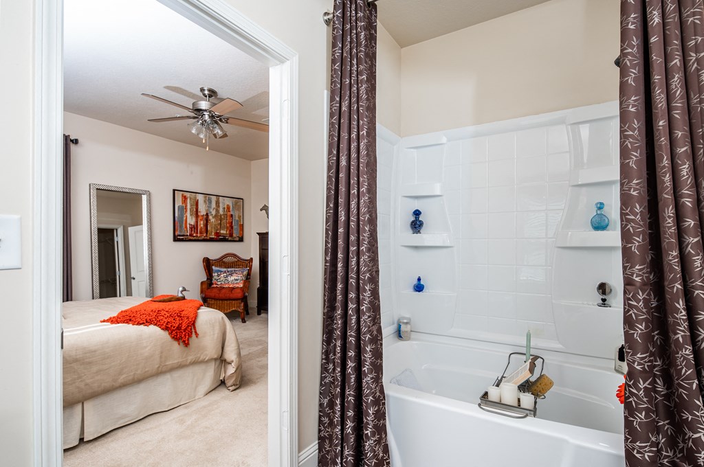 Bathroom with ceramic tub/shower with view of master bedroom at Riverstone apartments for rent in Macon, GA