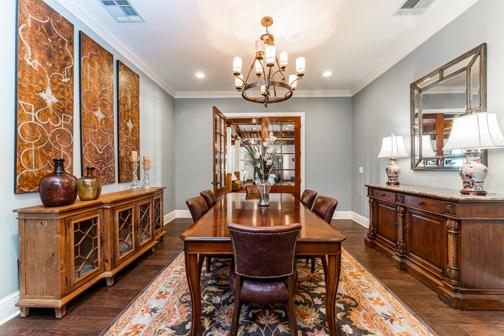 Clubhouse with long wooden table and chairs at Riverstone apartments for rent in Macon, GA