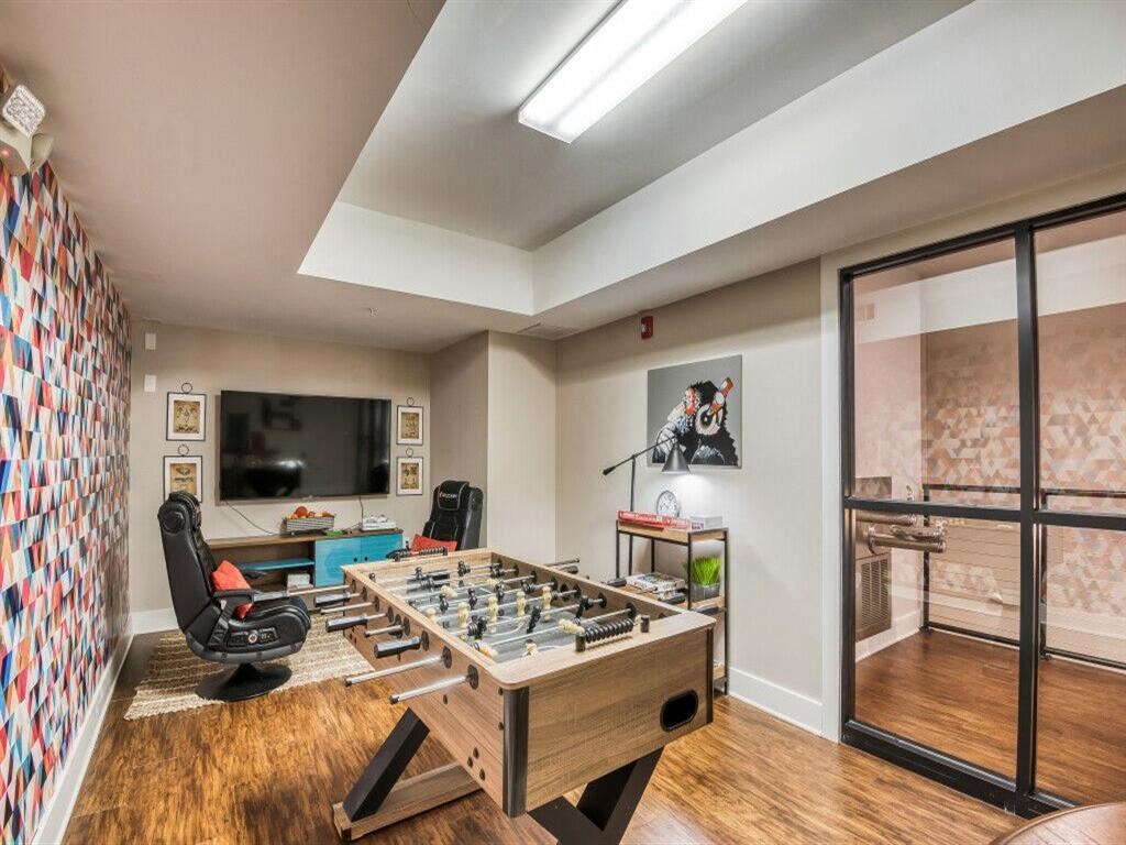 a game room with a foosball table and a television