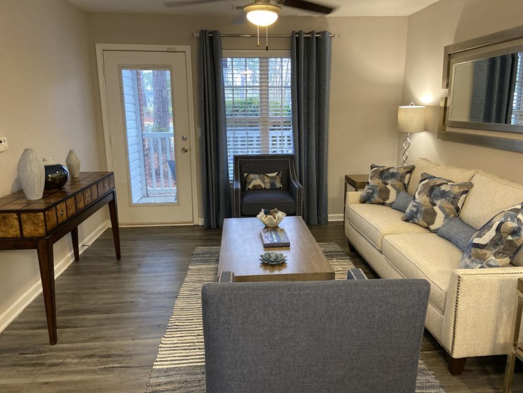 furnished apartment living room with wood-look flooring at Crescent Commons