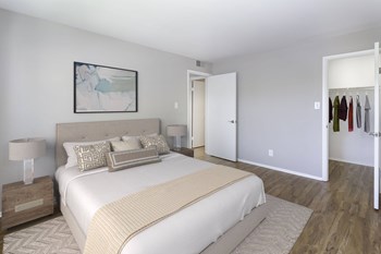 Renovated unit bedroom with wood-designed flooring at  Springwoods at Lake Ridge - Photo Gallery 16