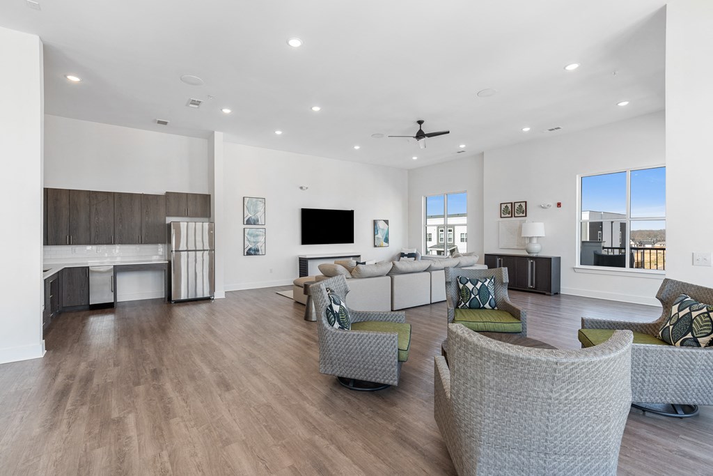 a living room with couches and chairs and a tv