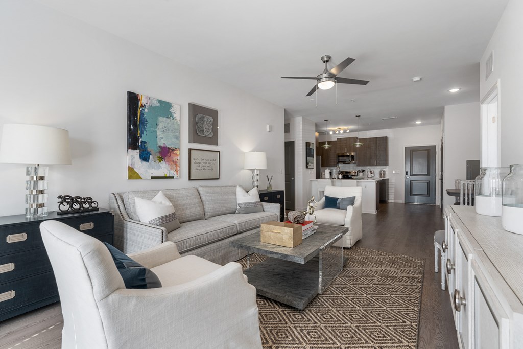 a living room with couches and chairs and a table