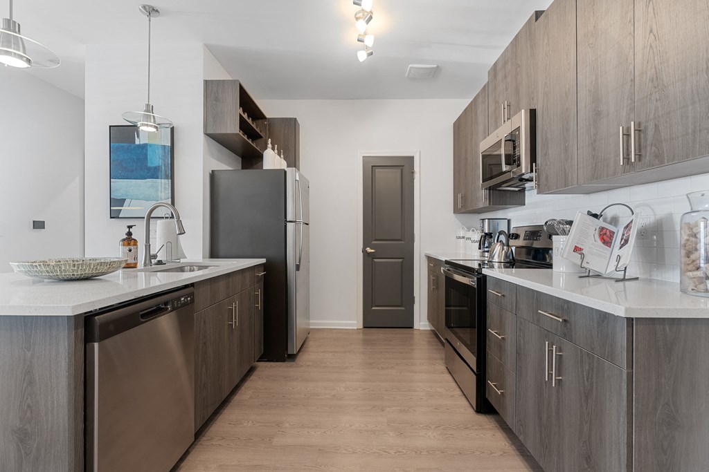 a kitchen with stainless steel appliances and wooden cabinets