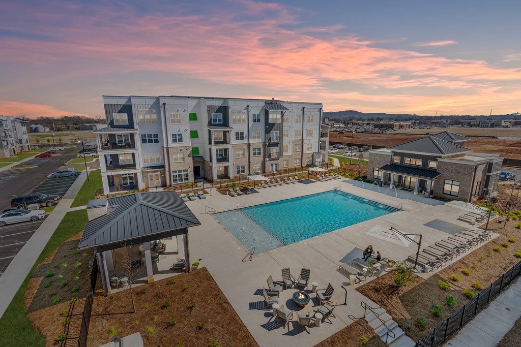 an aerial view of an apartment building with a swimming pool