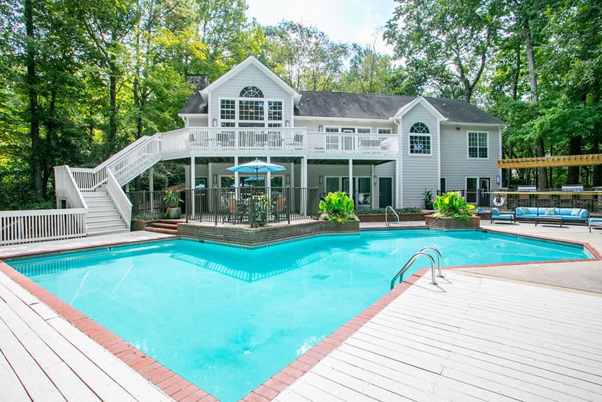 Sparkling swimming pool with sundeck and view of the clubhouse at Summerchase at Riverchase apartments for rent in Hoover, AL - Photo Gallery 1