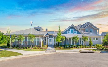 The Highland leasing office and resident clubhouse exterior with lush landscaping - Photo Gallery 5