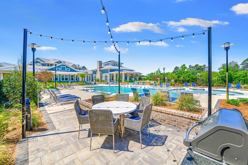 Poolside grilling station and al fresco dining with cafe lights at The Highland in Augusta, GA