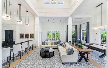 Resident clubhouse with communal kitchen, lounge area, and billiard table at The Highland in Augusta, GA