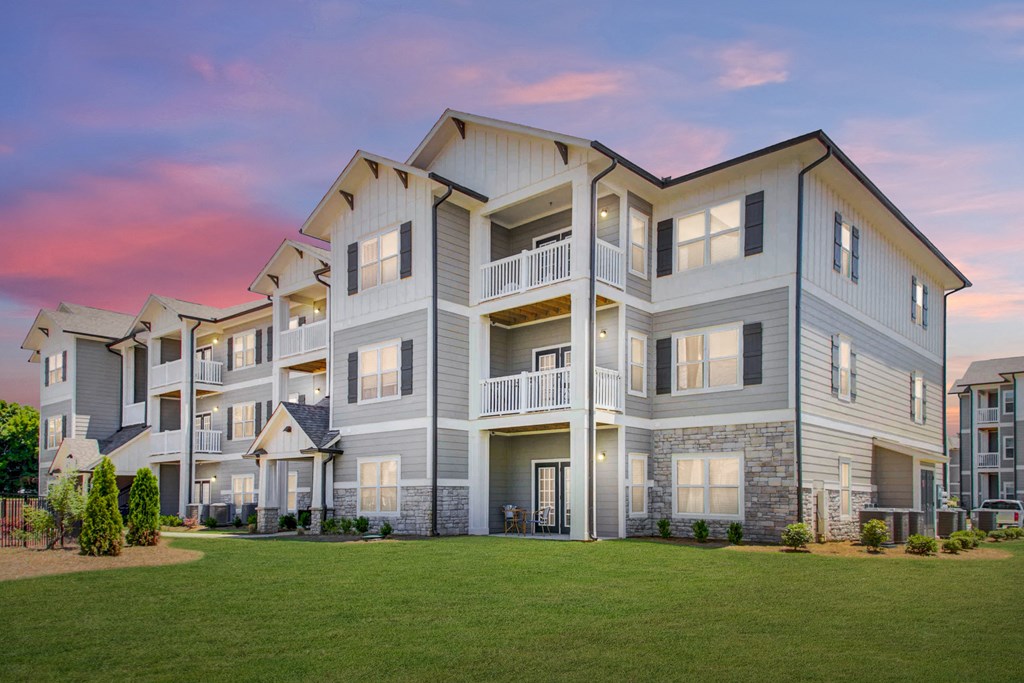 3D view of Three-story residential building with private patios and balconies with lush landscaping at The Alexandria in Madison, AL