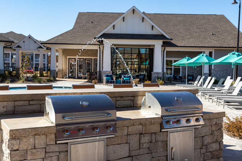Madison, AL poolside grilling pavilion with gas grills, bar-style seating, and tables next to the resort-style swimming pool at The Alexandria Madison, AL poolside grilling pavilion with gas grills, bar-style seating, and tables next to the resort-style swimming pool at The Alexandria