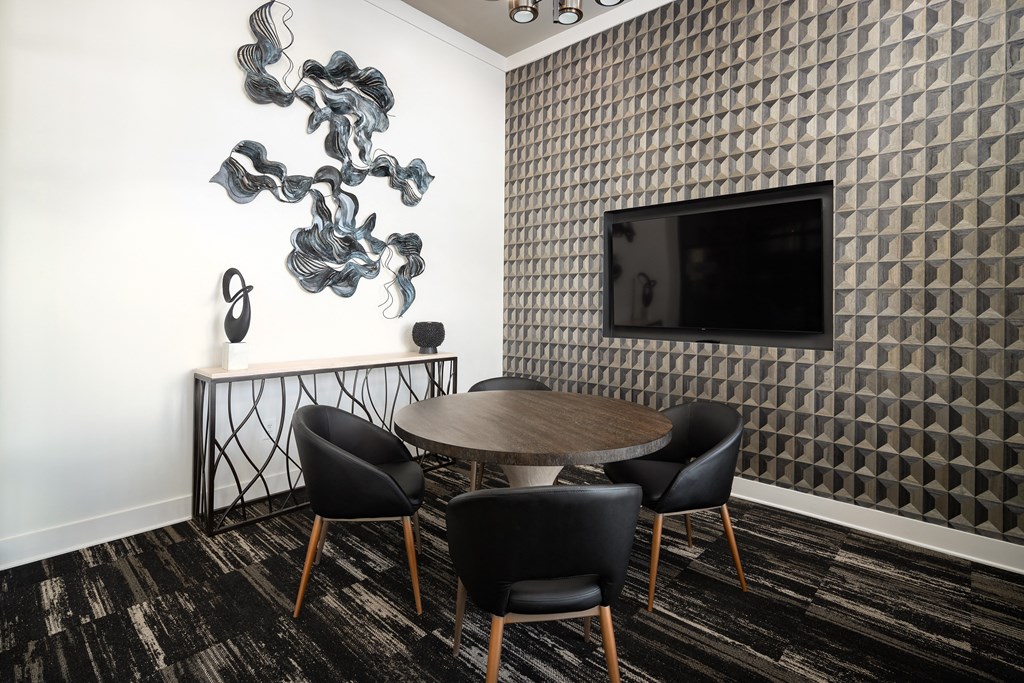 Conference room with dining chairs, large TV, carpet flooring, and high ceiling at The Alexandria in Madison, AL