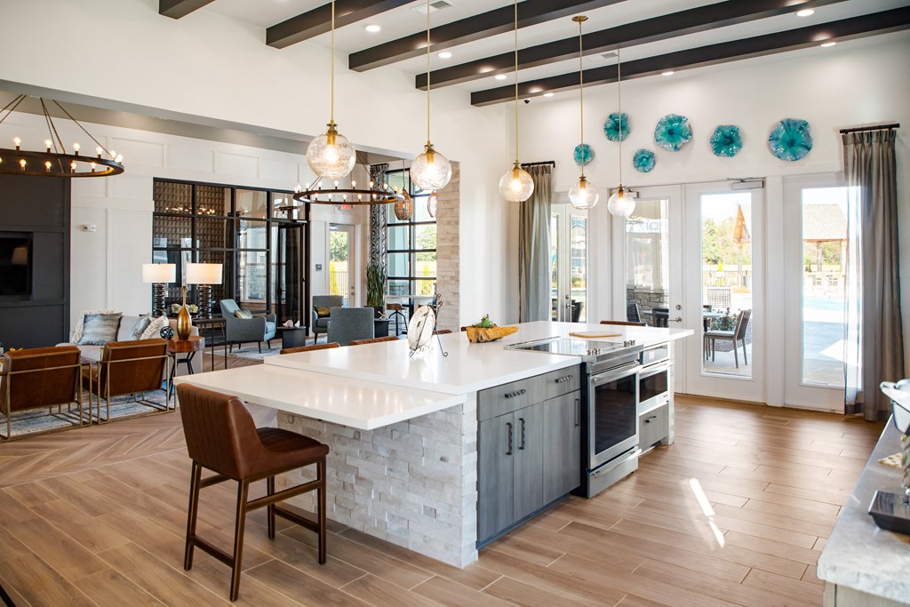 The Alexandria communal kitchen with bar-style seating and wood-designed flooring in Madison, AL