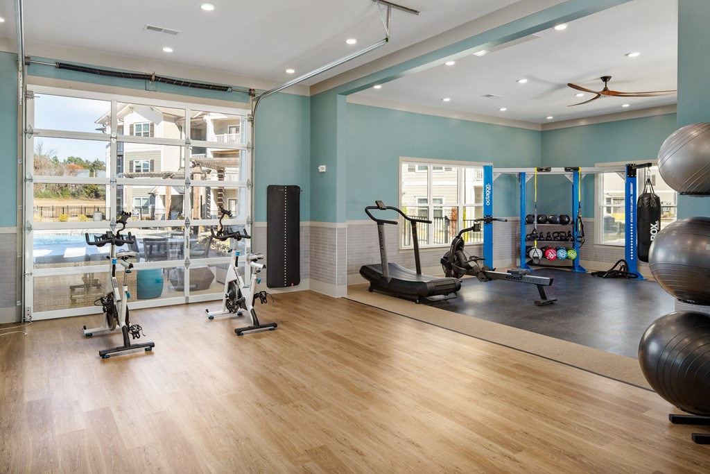 The Alexandria premium fitness center with exercise equipment and wood-designed flooring in Madison, AL