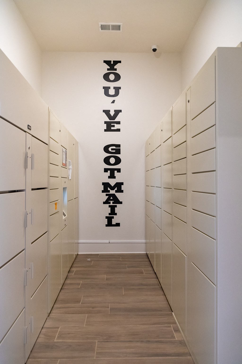 Package concierge locker area with wood designed flooring at The Alexandria in Madison, AL