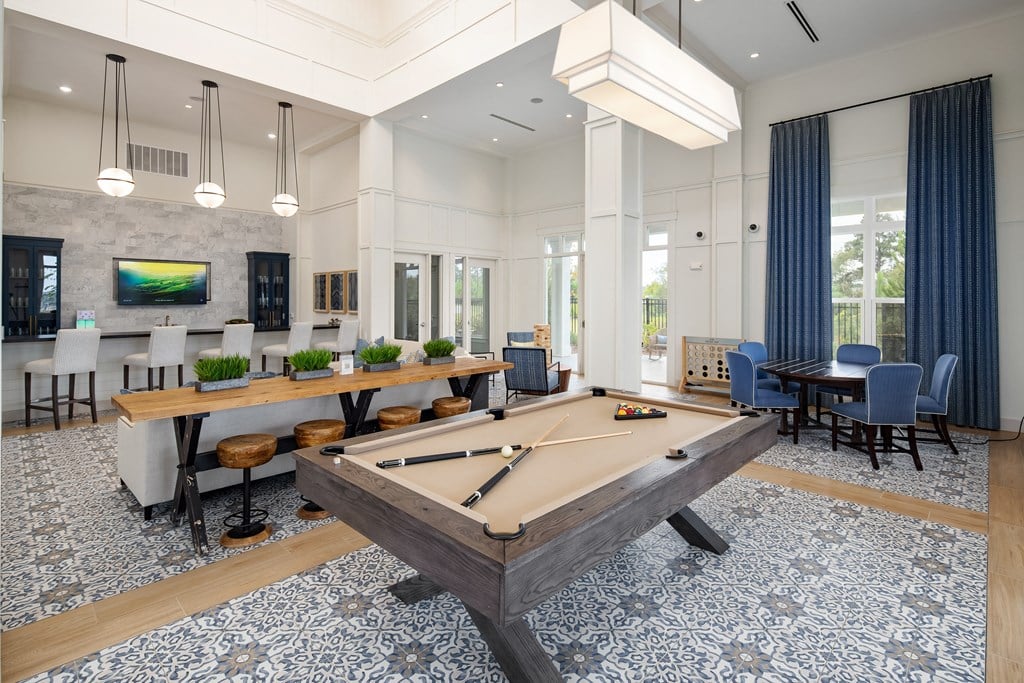 Resident clubhouse with billiard table and seating areas at The Highland in Augusta, GA