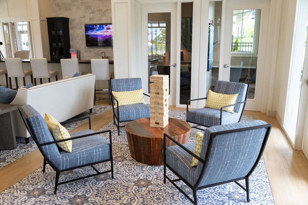 Resident clubhouse with various seating areas and games at The Highland in Augusta, GA