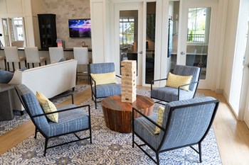 Resident clubhouse with various seating areas and games at The Highland in Augusta, GA - Photo Gallery 13