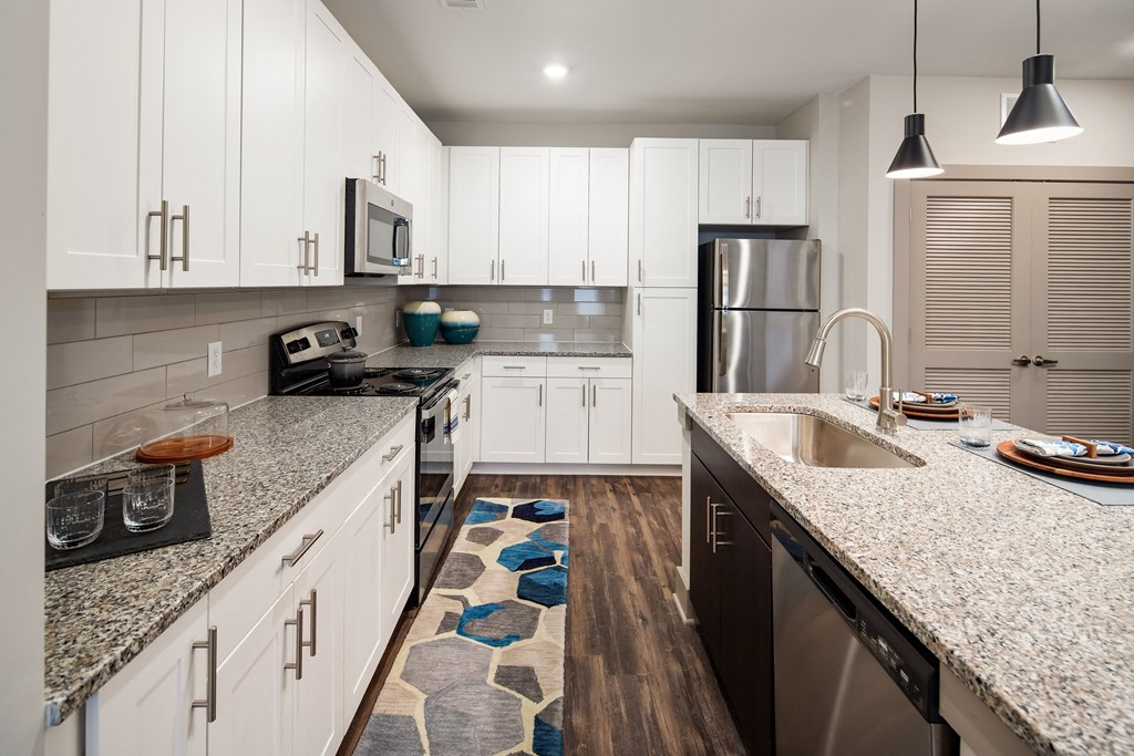Kitchen with granite countertops and shaker-style cabinets at The Highland in Augusta, GA