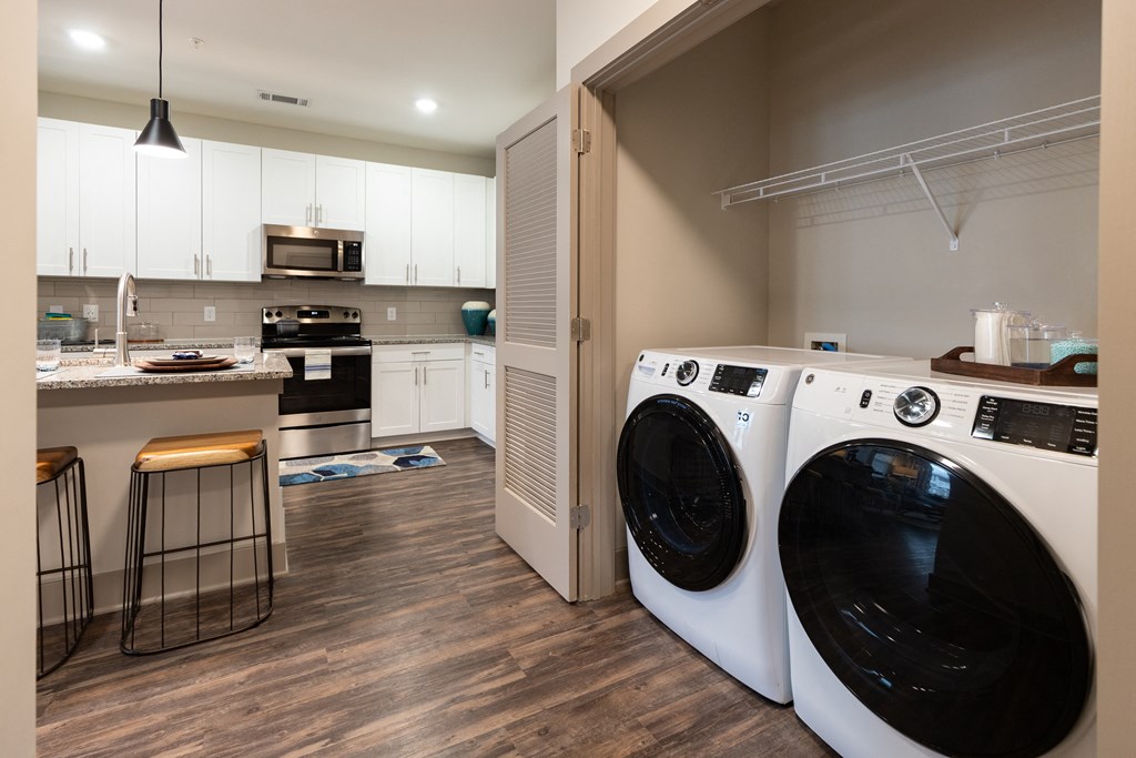 In-unit laundry with washer, dryer, and built-in shelving at The Highland in Augusta, GA