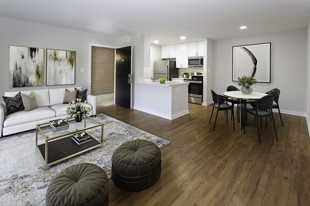 Kitchen, living and dining area with wood-designed flooring and kitchen bar at Windsor Park in Woodbridge, VA