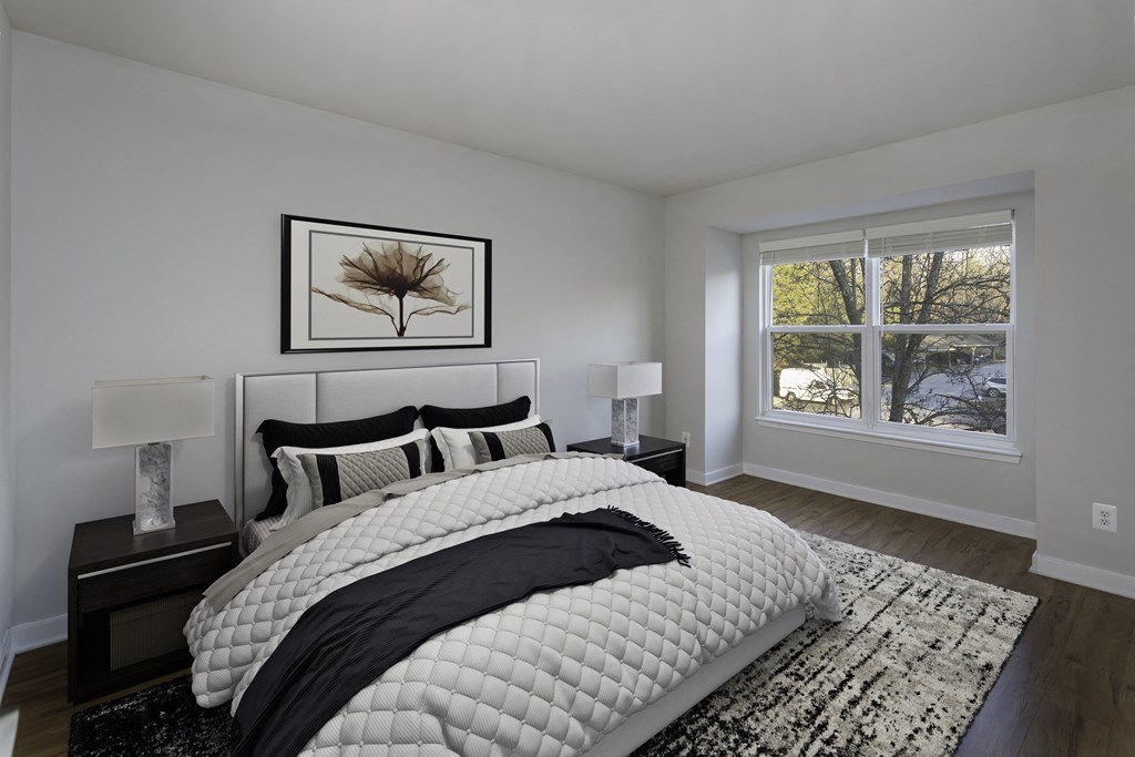 Bedroom with wood-designed flooring and large window at Windsor Park in Woodbridge, VA