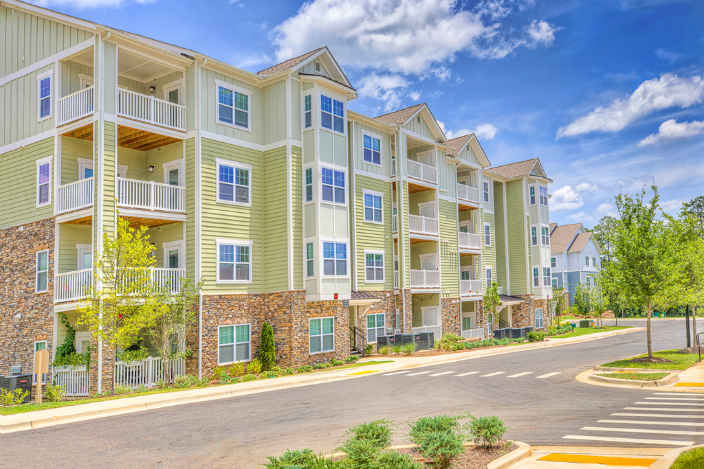Residential building painted white and green at Lullwater at Blair Stone apartments for rent in Tallahassee, FL