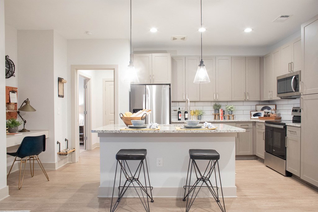 Open concept apartment kitchen with wood floors at Foundry Yards in Birmingham, AL