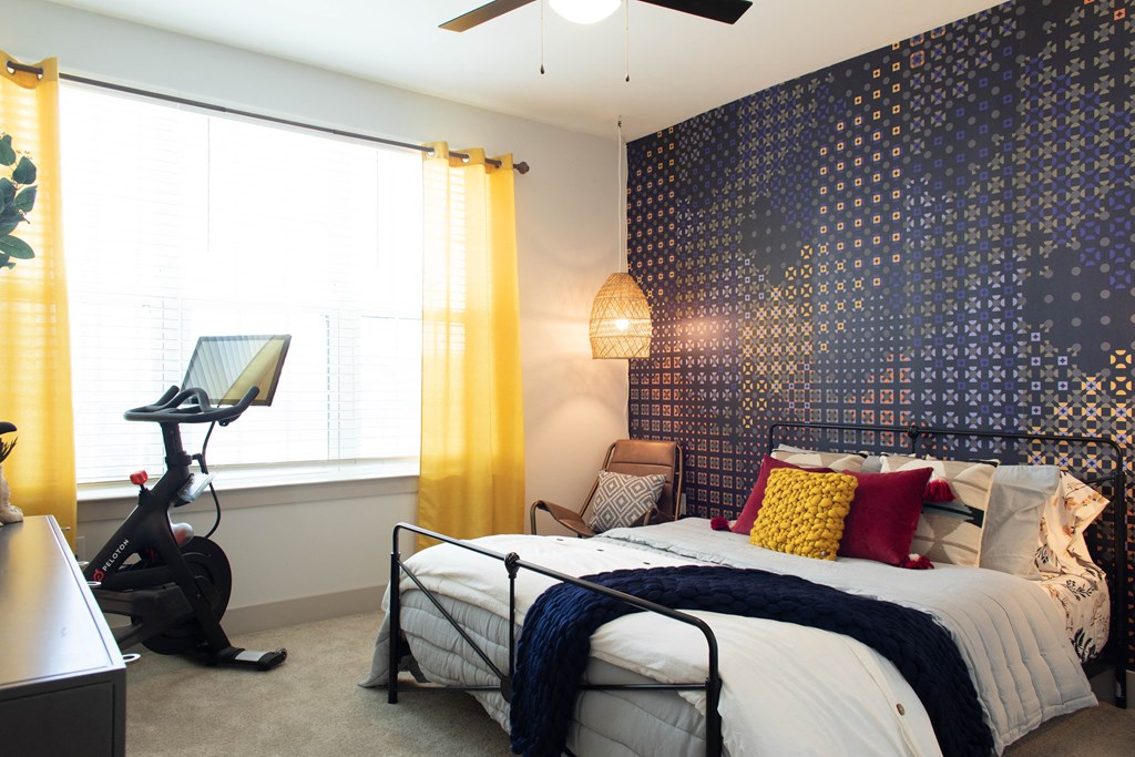 Apartment bedroom with ceiling fan and large windows at Foundry Yards in Birmingham