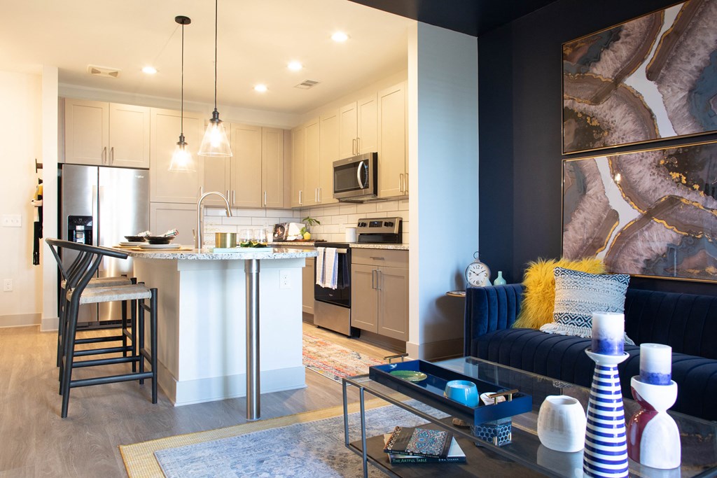 Apartment kitchen with island and stainless steel appliances in Birmingham, AL at Foundry Yards