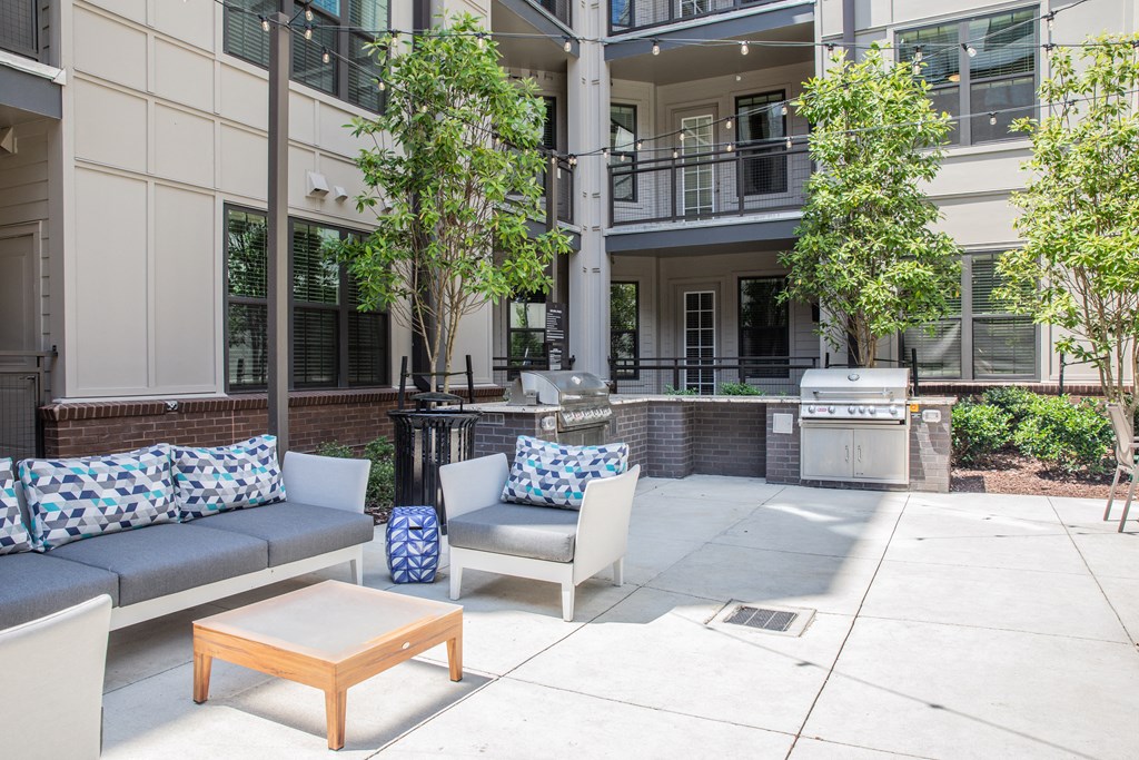 Apartment complex common space with outdoor grills and seating in Birmingham, AL
