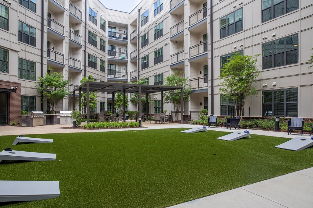 Foundry Yards apartment community outdoor space with yard games and grilling stations.