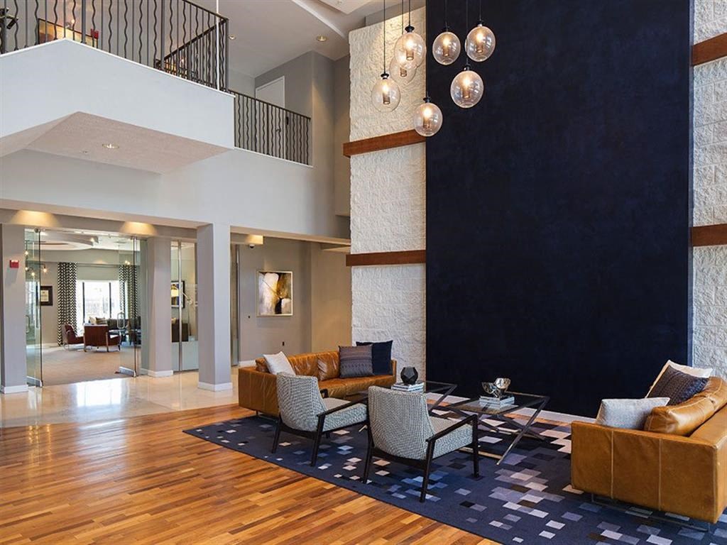 a living room with a couch and chairs and a table