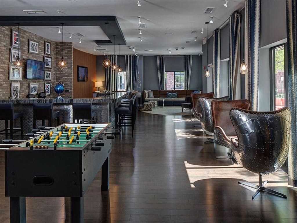 a game room with a pool table and a bar