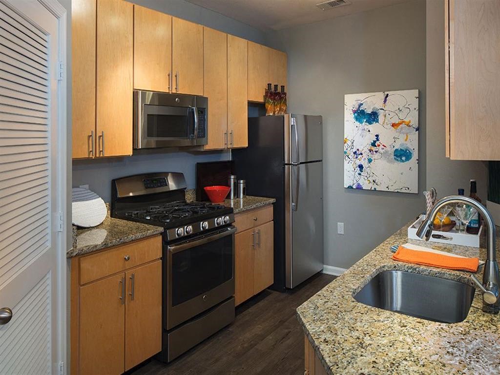 a kitchen with stainless steel appliances and granite counter tops