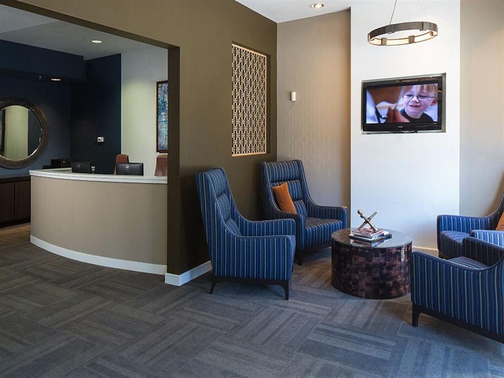 a waiting room with chairs and a tv