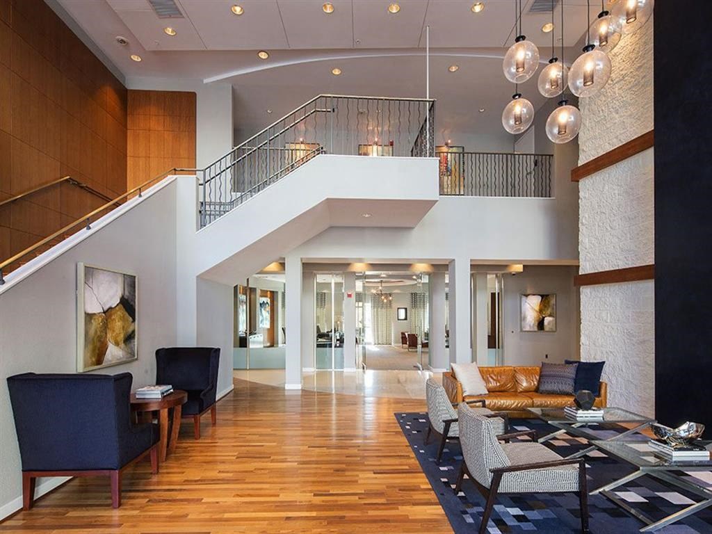 a large living room with furniture and a staircase