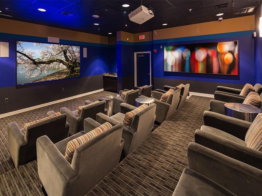 a large screening room with blue walls and chairs