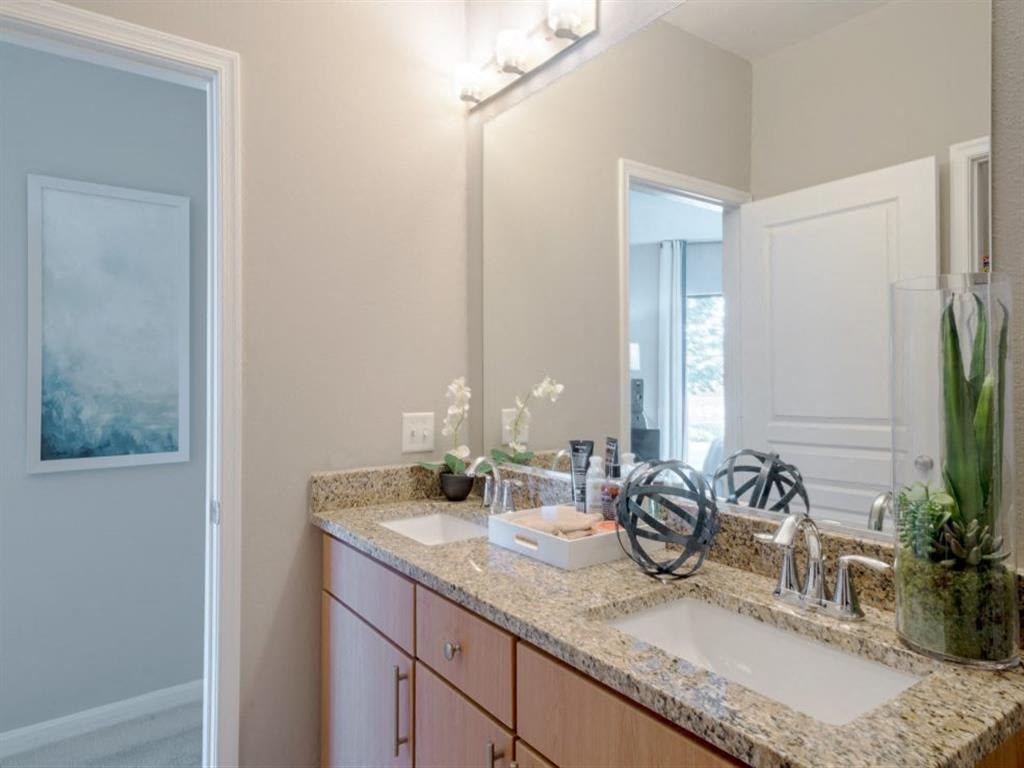 a bathroom with two sinks and a mirror