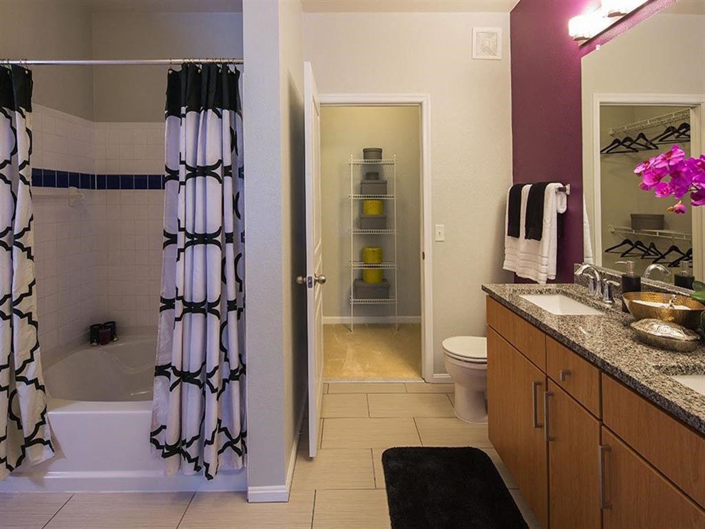 a bathroom with a shower and a sink and a toilet