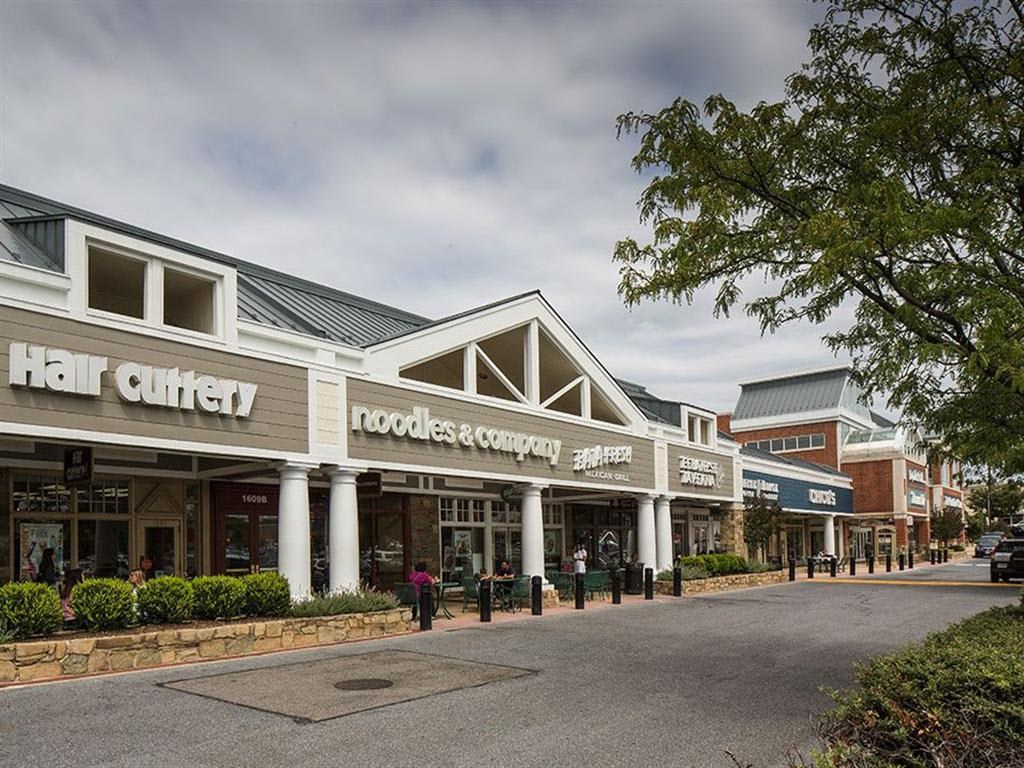 a row of shops on the side of a street