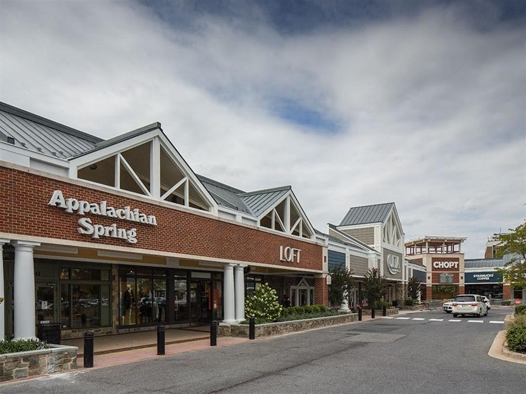 a store front of a shopping center on a city street