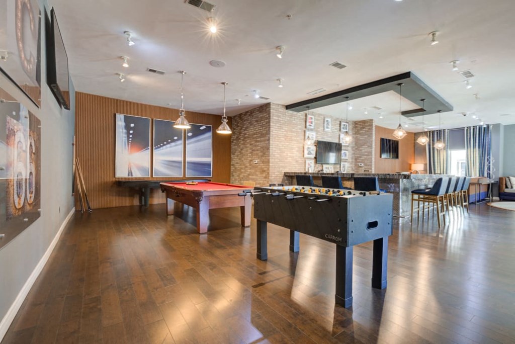 a game room with a pool table and a bar