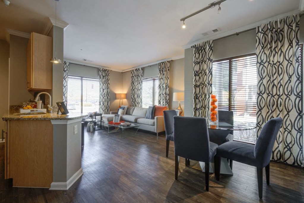 a living room and kitchen with a table and chairs